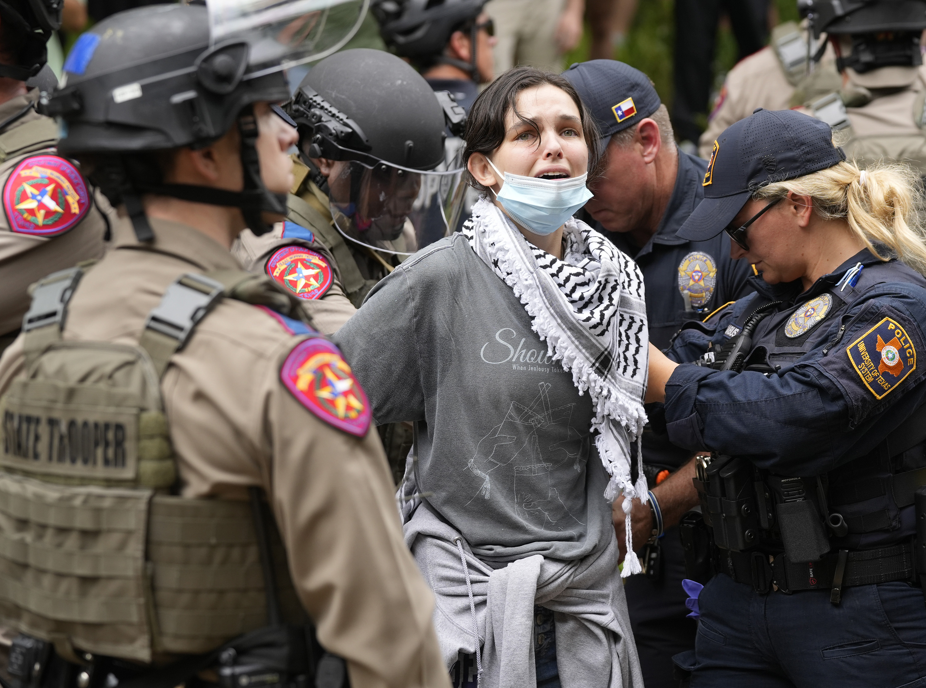 美国德州大学奥斯汀分校24日传出示威学生和大批警力爆发肢体冲突，当局证实至少20人被逮捕。图可见现场一名女性遭警方制伏逮捕。美联社